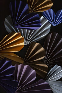 High angle view of colorful paper hearts arranged on black background