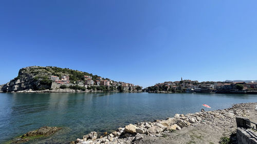 Scenic view of bay against clear blue sky