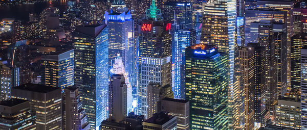 Illuminated modern buildings in city at night