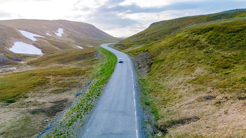 Road amidst mountains against sky