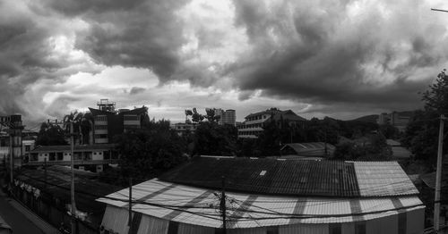 High angle view of buildings against cloudy sky