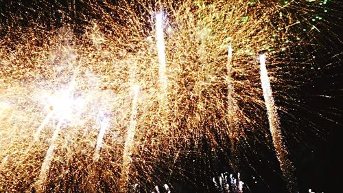 Low angle view of firework display at night