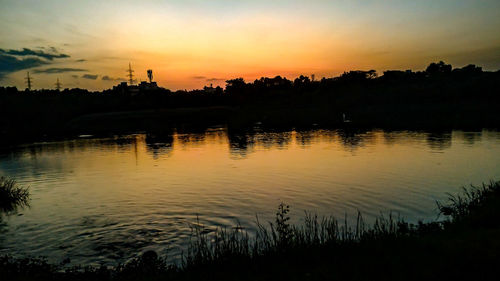 Scenic view of lake at sunset