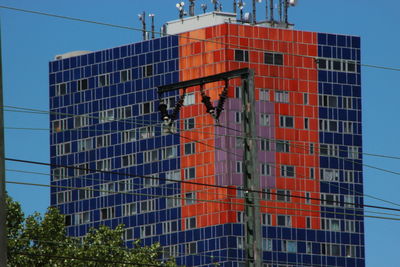 Low angle view of buildings against clear blue sky