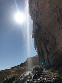 Low angle view of rock formation against sky