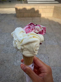 Close-up of hand holding ice cream cone