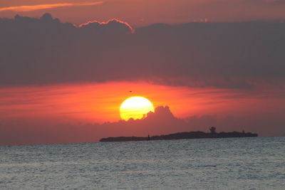 Scenic view of sea against orange sky