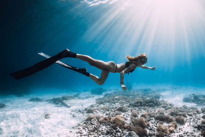 Side view of woman swimming in sea