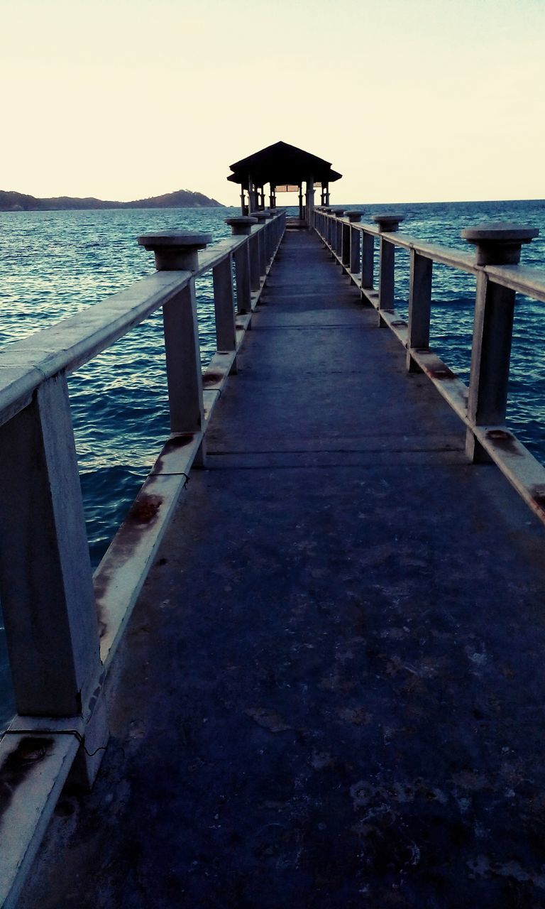 water, sea, pier, built structure, clear sky, railing, the way forward, horizon over water, tranquility, tranquil scene, jetty, wood - material, architecture, scenics, nature, diminishing perspective, beauty in nature, sky, long, rippled