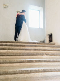 Rear view of couple holding hands