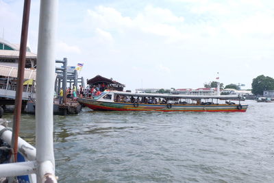 Boats in sea with buildings in background