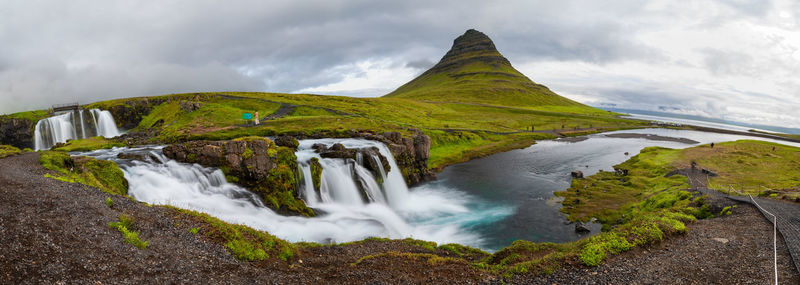 Scenic view of waterfall against sky