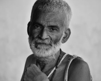 Portrait of smiling senior man against blurred background