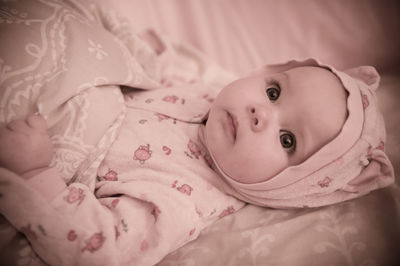 Close-up of cute baby boy sleeping on bed at home