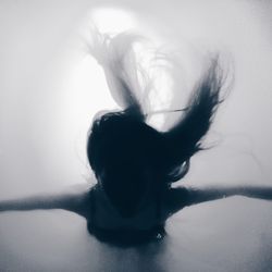 Close-up of woman relaxing on wall