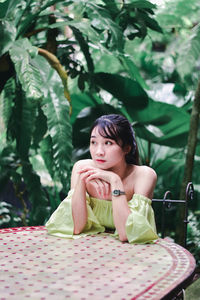 Portrait of young woman sitting outdoors
