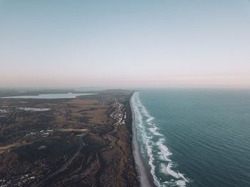 Aerial view of sea against clear sky