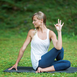 Woman practicing yoga in park