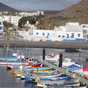 Boats moored in harbor by buildings in city