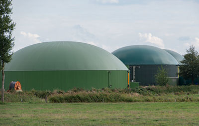 Built structure on field against sky