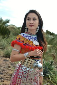 Close-up of woman wearing traditional clothes while standing on field