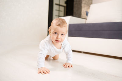 Portrait of cute baby crawling at home