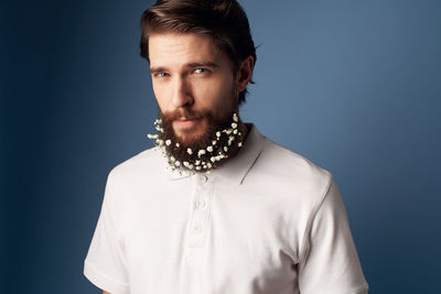 Portrait of mid adult man against blue background