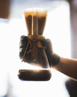 Close-up of hand holding coffee cup