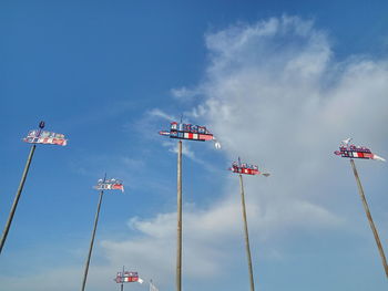 Low angle view of flags against sky