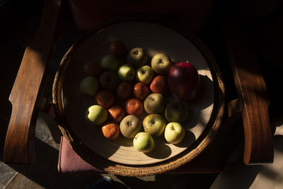 High angle view of grapes in bowl on table