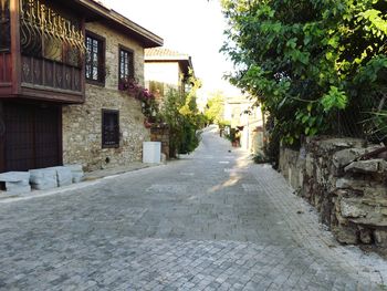 Empty alley amidst buildings in city