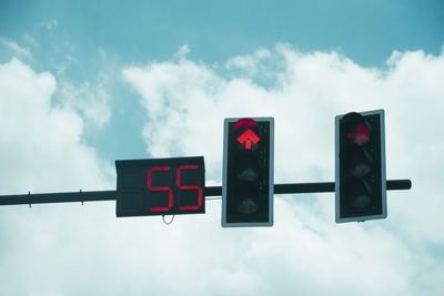 Low angle view of road sign against sky