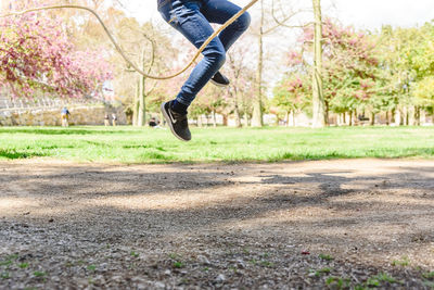 Low section of man jumping in park