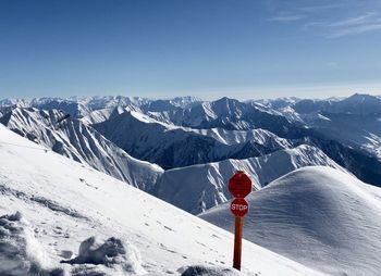 Scenic view of snow covered mountains against sky