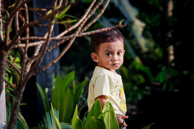 Portrait of cute boy standing outdoors