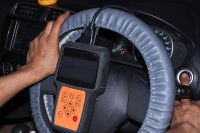 Cropped hand of man driving car