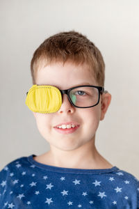 Portrait of young woman wearing sunglasses against white background