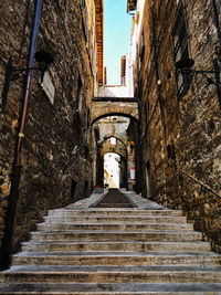 Low angle view of staircase amidst buildings