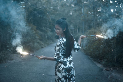 Young woman holding umbrella