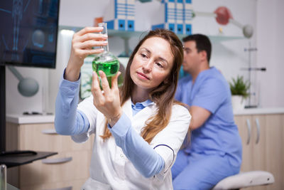 Portrait of smiling female friends standing in laboratory