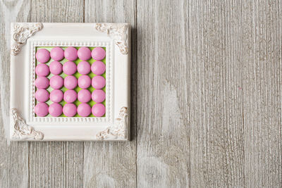 Directly above shot of pink fruits on wood