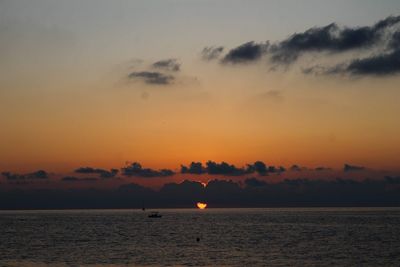 Scenic view of sea against orange sky