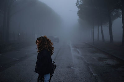 Young woman standing on road