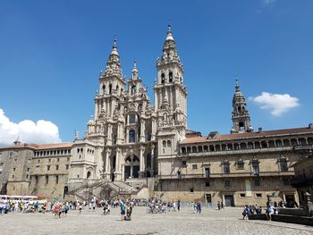 Group of people in front of building against sky