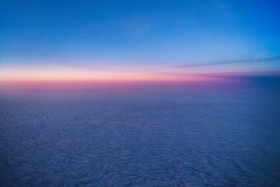 Scenic view of landscape against blue sky during sunset