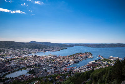 High angle view of townscape by sea against sky