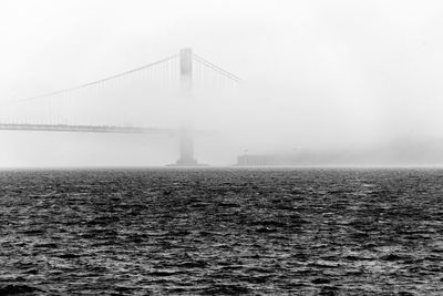 View of suspension bridge in foggy weather