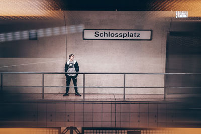 Full length of man standing at subway station