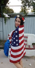 Portrait of smiling young woman standing outdoors