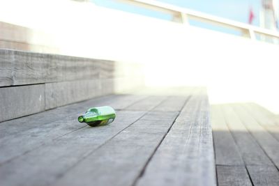 Surface level of beer bottle on wooden steps